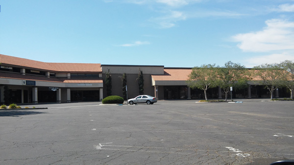 A shopping center sits empty, in anticipation of its demolition for the new freeway.