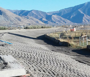 Figure 4 Soil slope --- A gentle 1:6 slope (approx.) at the edge of a new road under construction in Provo, Utah