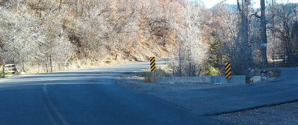 Figure 5 Right-Angle Obstruction - A longitudinal barrier near Payson, Utah that has been turned perpendicular to traffic. The barrier's right angle now acts as a dangerous rigid obstruction.